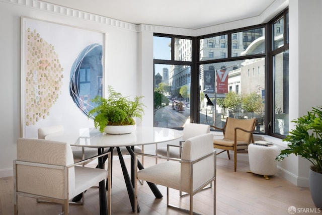 dining space with hardwood / wood-style floors