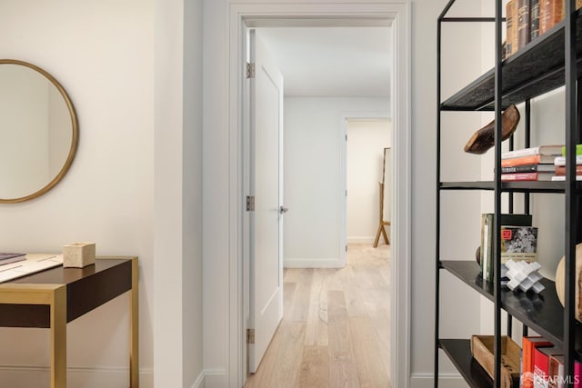 corridor with light hardwood / wood-style floors