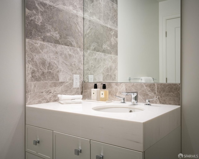 bathroom with vanity and tasteful backsplash