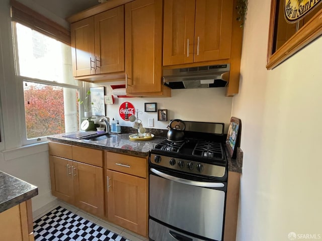 860 Bush St, San Francisco, CA 94108 - kitchen with brown cabinets, a sink, under cabinet range hood, and gas range