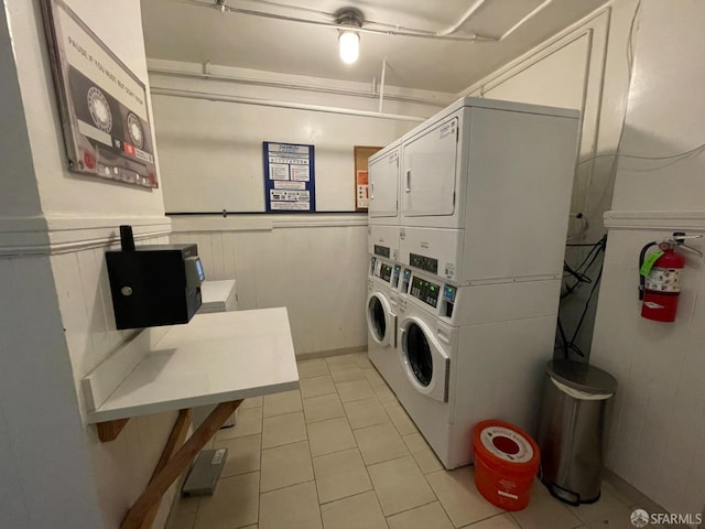 860 Bush St, San Francisco, CA 94108 - community laundry room with stacked washer and dryer, wainscoting, washer and clothes dryer, and light tile patterned floors