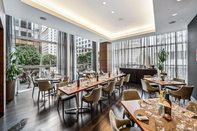 dining space featuring hardwood / wood-style floors, plenty of natural light, and floor to ceiling windows