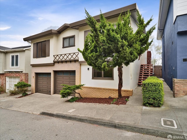 173 Warren Dr, San Francisco, CA 94131 - view of front of home with brick siding, a garage, stairs, stucco siding, and driveway