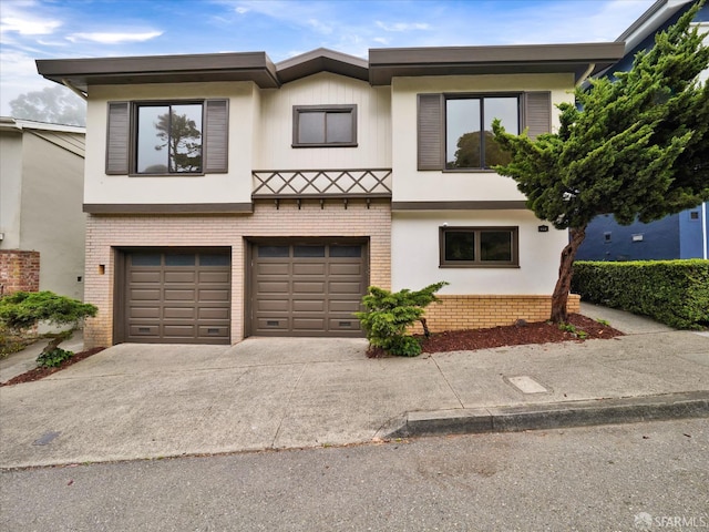 173 Warren Dr, San Francisco, CA 94131 - view of front of house with brick siding, driveway, an attached garage, and stucco siding
