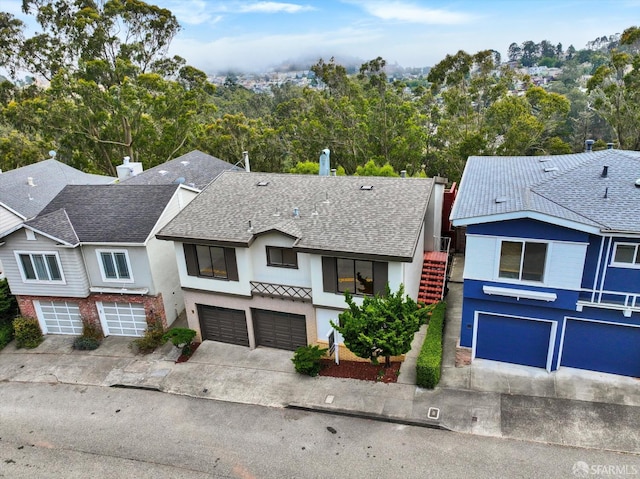 173 Warren Dr, San Francisco, CA 94131 - view of front of home with a garage, stucco siding, driveway, and stairway