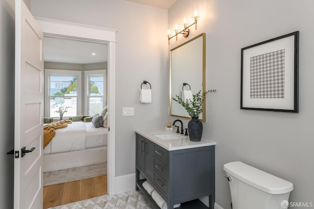 bathroom featuring vanity, hardwood / wood-style floors, and toilet