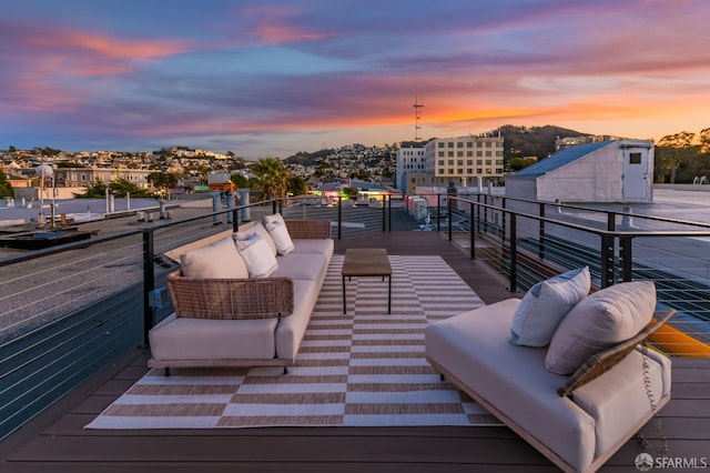 balcony at dusk featuring an outdoor hangout area