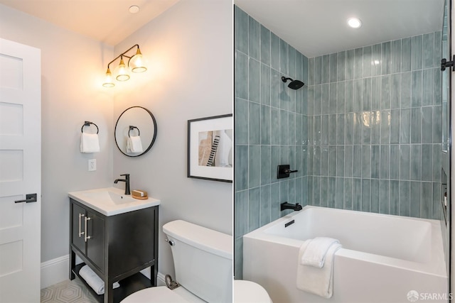 full bathroom featuring vanity, tiled shower / bath combo, and toilet