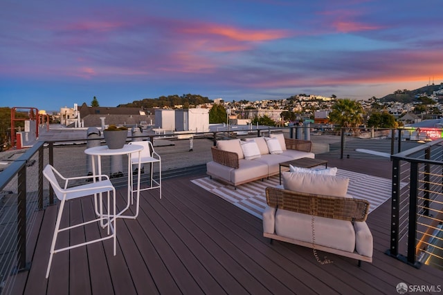 deck at dusk with an outdoor hangout area