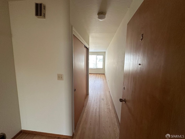 hall with light wood-type flooring