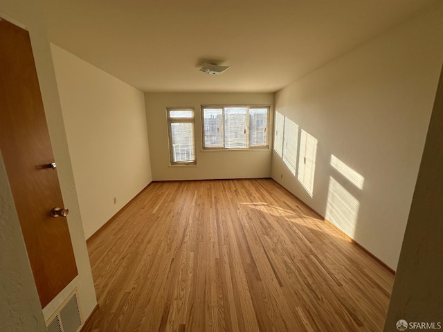 unfurnished room featuring light hardwood / wood-style floors