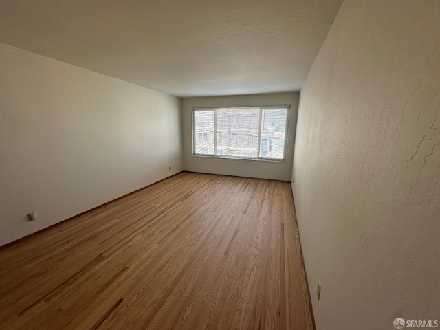 spare room with light hardwood / wood-style floors