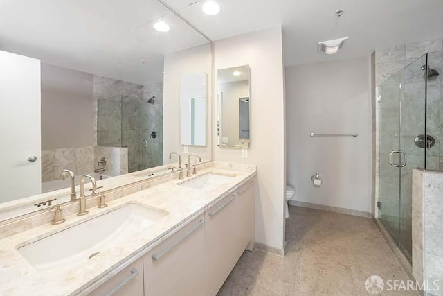 bathroom featuring vanity, an enclosed shower, and toilet