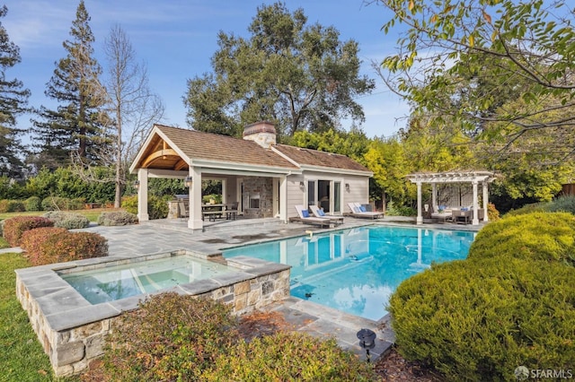 view of pool featuring a patio area, a pergola, and an in ground hot tub