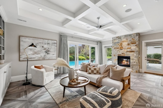 living room featuring a fireplace, light parquet floors, ceiling fan, and coffered ceiling