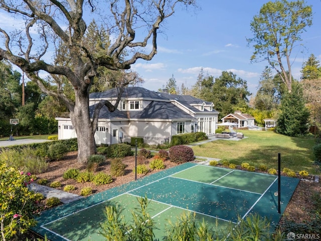 view of sport court featuring a yard