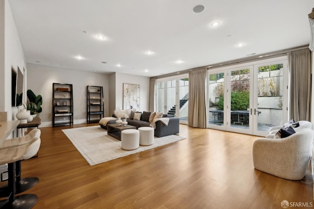 living room featuring light hardwood / wood-style flooring and french doors