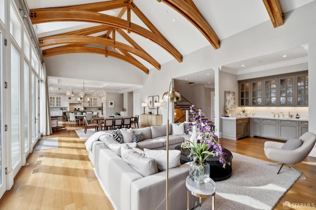 living room with light wood-type flooring and vaulted ceiling