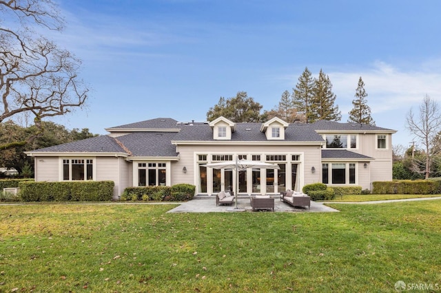 rear view of property featuring a lawn, outdoor lounge area, and a patio area