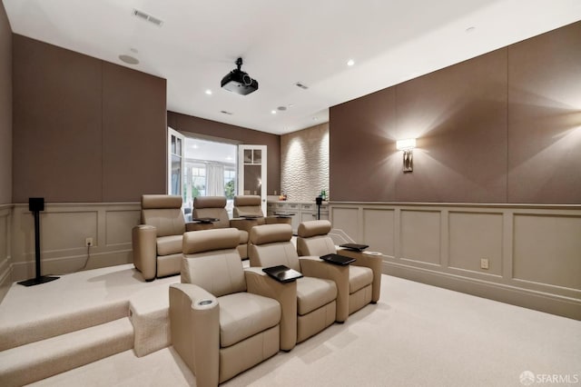 home theater room with light colored carpet