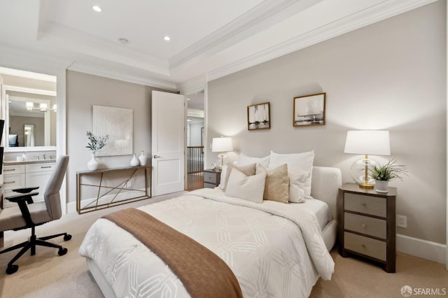 bedroom featuring light carpet, ensuite bathroom, a raised ceiling, and ornamental molding