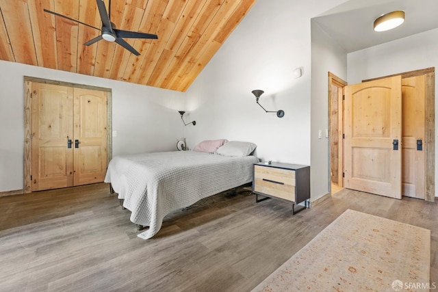 bedroom with lofted ceiling, wooden ceiling, and wood finished floors