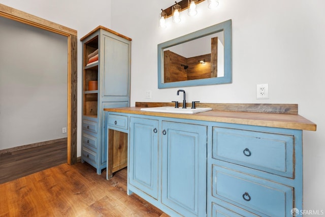 bathroom with wood finished floors and vanity