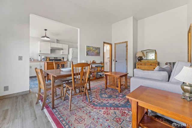 dining space with light hardwood / wood-style floors and sink