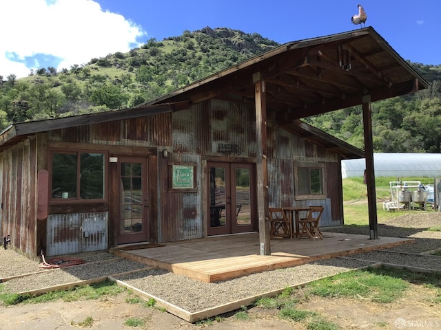 exterior space with french doors and a deck