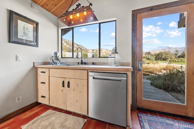 kitchen with light brown cabinetry, sink, dark hardwood / wood-style floors, a mountain view, and stainless steel dishwasher