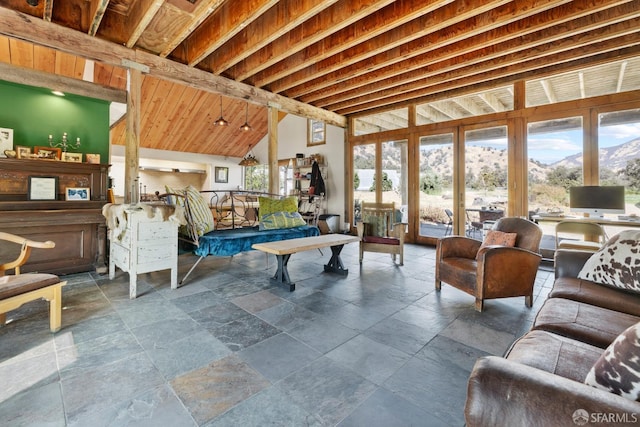 living area with high vaulted ceiling and stone tile flooring