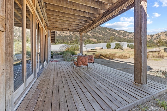 deck featuring fence and a mountain view