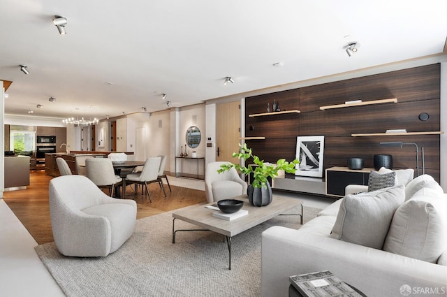 living room with wood walls and light wood-type flooring