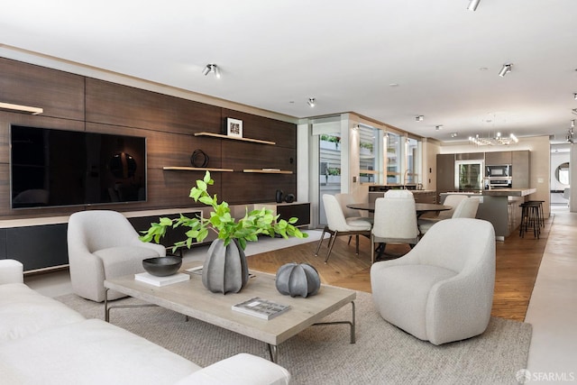 living room with light hardwood / wood-style flooring and a notable chandelier