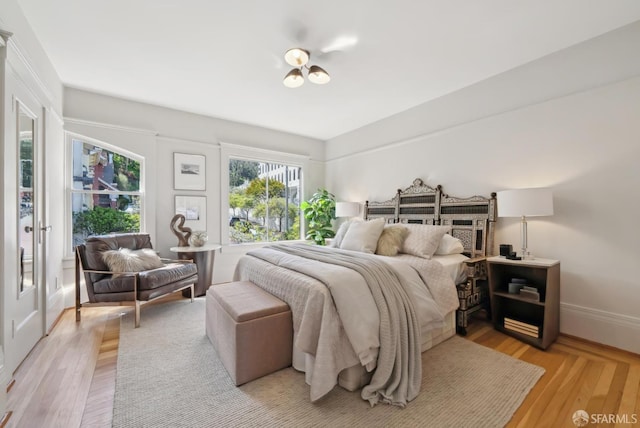 bedroom featuring light wood-type flooring and baseboards