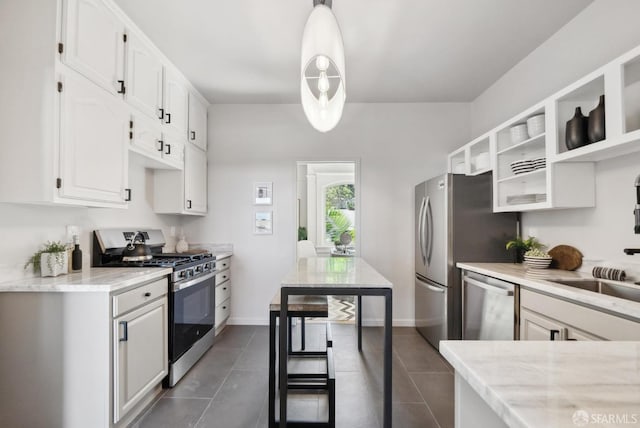 kitchen featuring baseboards, stainless steel appliances, dark tile patterned floors, white cabinetry, and open shelves