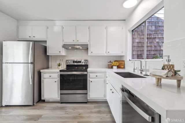 kitchen with sink, white cabinetry, plenty of natural light, stainless steel appliances, and decorative backsplash