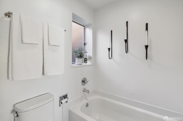 bathroom with toilet and a bathing tub