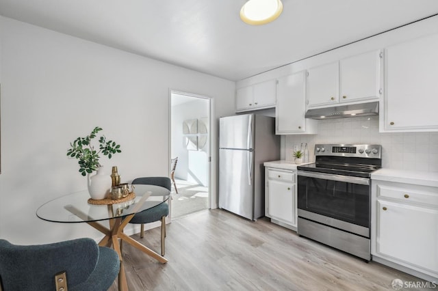 kitchen with white cabinetry, appliances with stainless steel finishes, light wood-type flooring, and backsplash