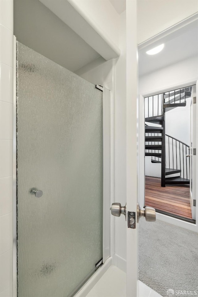 bathroom featuring a shower with shower door