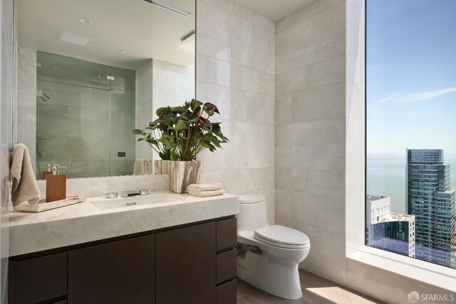 488 Folsom St Unit 5501, San Francisco, CA 94105 - full bath with tile walls, vanity, toilet, and a stall shower