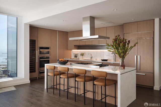 488 Folsom St Unit 5501, San Francisco, CA 94105 - kitchen featuring wall chimney range hood, modern cabinets, dark wood-style floors, light countertops, and stainless steel appliances