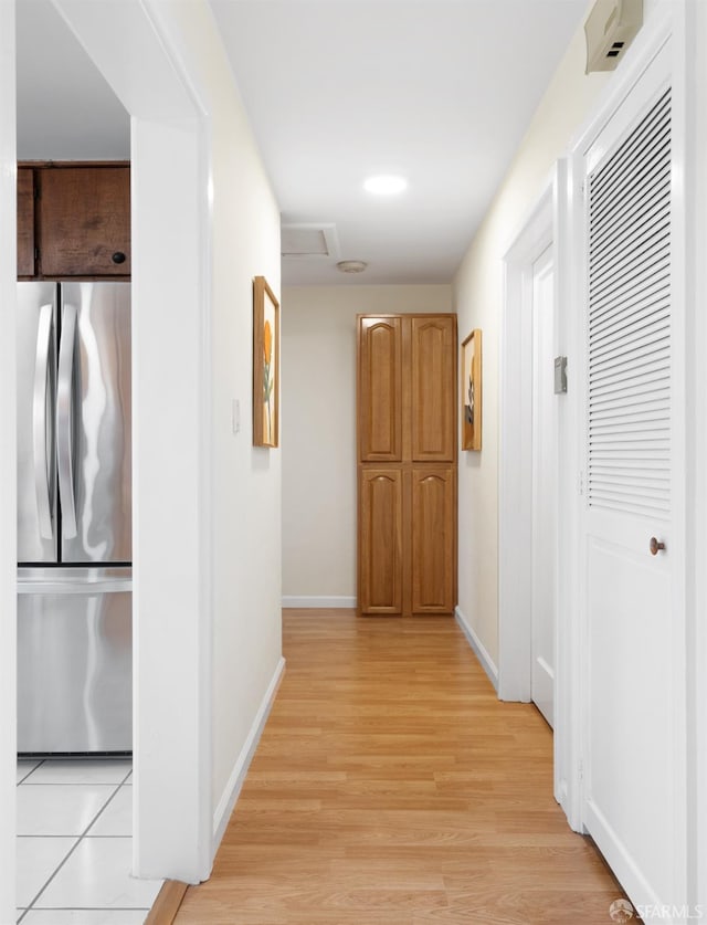 hallway with light wood finished floors and baseboards