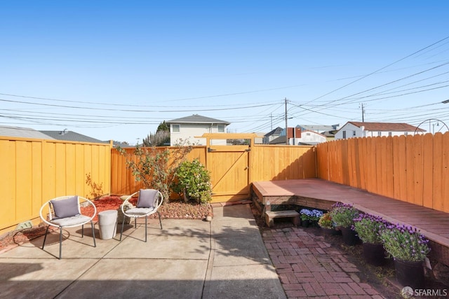 view of patio featuring a fenced backyard and a gate