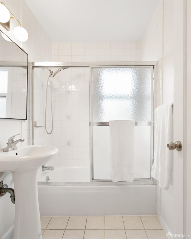 bathroom with shower / bath combination with glass door and tile patterned floors