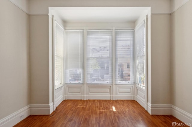 spare room with hardwood / wood-style floors