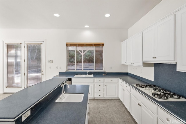 kitchen with white gas cooktop, sink, white cabinets, and light tile patterned floors