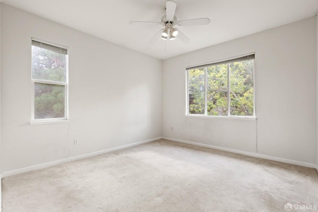 carpeted empty room featuring ceiling fan