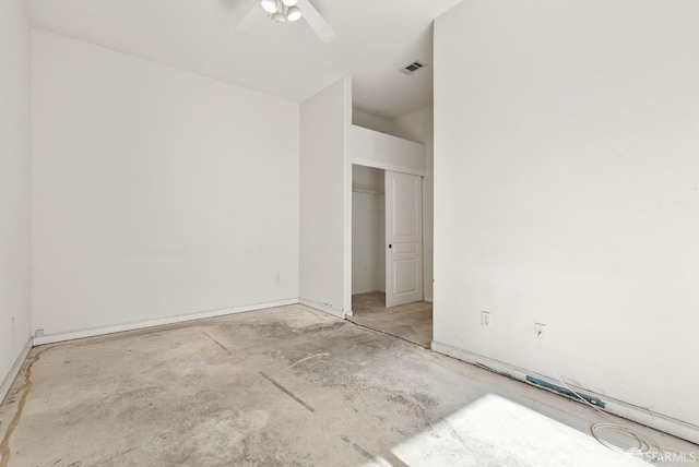 empty room featuring ceiling fan and concrete flooring