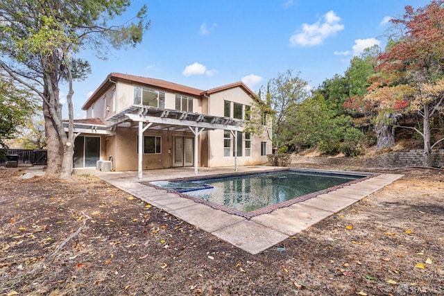 rear view of house featuring a pergola and a patio